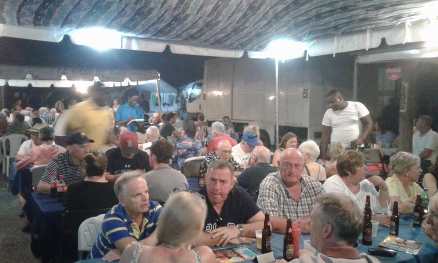 Bridgetown: Oistins reservation with drink & return transfer - Ordering grilled fish and local dishes